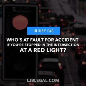 Who's at fault for an accident if you're stopped in the intersection at a red light?