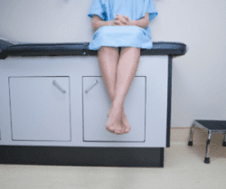 Woman Sitting on Doctor's Table
